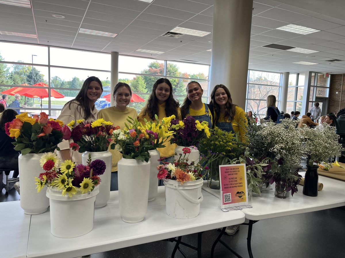 Members of the garden club sell bouquets to students during lunch.