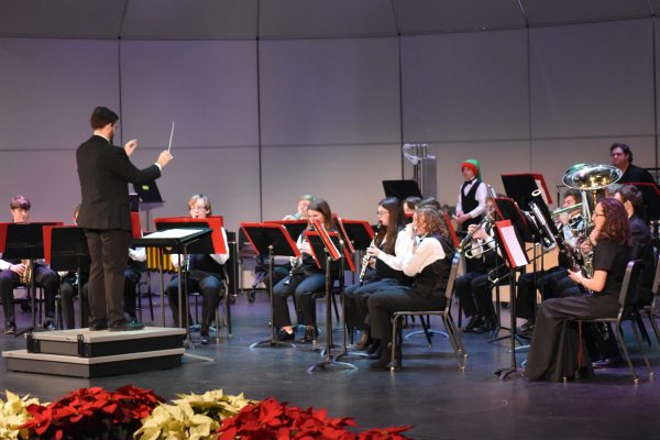 Brighton High School band director Joseph Swinkey leads the Brighton bands through their final concert of the 2024 season.