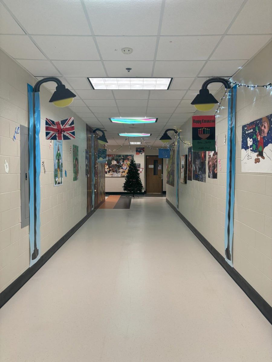 A "Carzonie Holiday Movie Festival," featuring photoshopped movie posters and hand-painted murals of Brighton businesses, ultimately took first place in the annual teacher door-decorating competition.