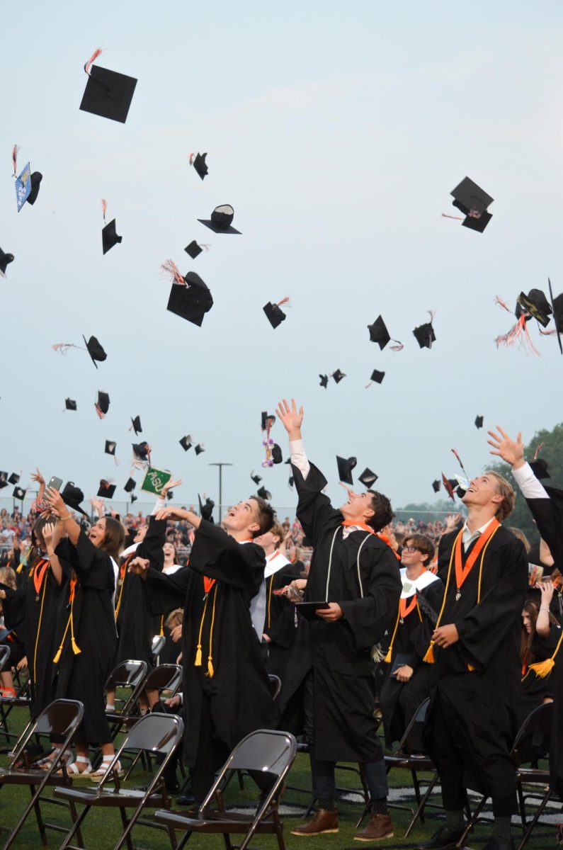 BHS seniors throw their graduation caps into the air.