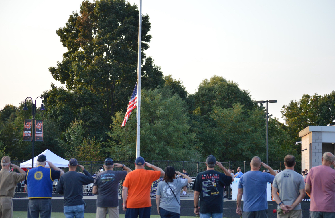 Veterans salute the American flag during Veterans Appreciation Night on Friday, Sept. 19.