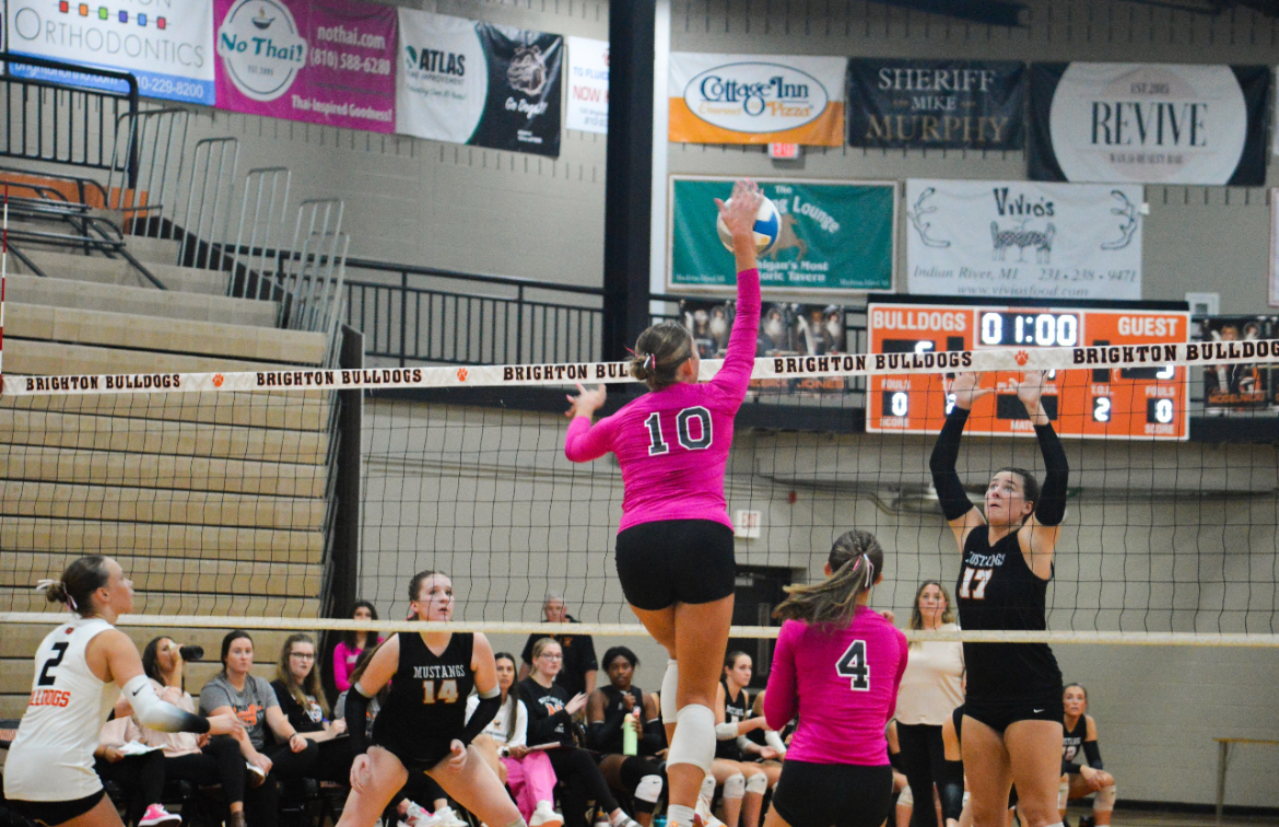 Junior middle blocker Cynthia Ockerman hits a ball across the net for a kill at a Sept. 23, 2025 game against Northville High School. 
