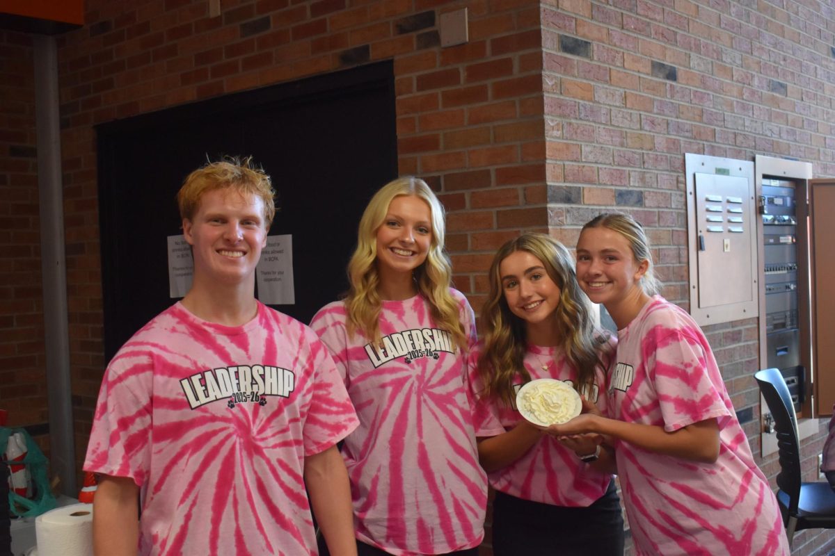 Senior Leadership students Erik DeKeyser, Elle Robinson, Sophia Tepper and Maya Bjedov pose for a picture while helping with the "pie-in-the-face" station at lunch.