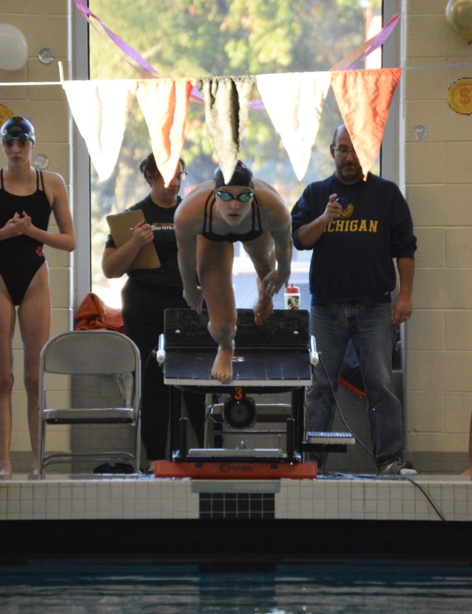 Brighton sophomore Katherine Gray dives off the block for the 200-yard individual medley. A two-sport athlete, Gray has struggled with minor injuries that have jeopardized her participation and impacted her performance.
