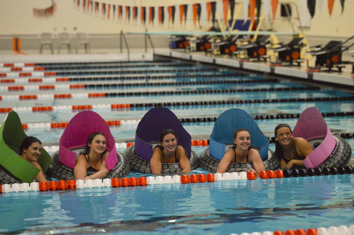 Brighton girls swim and dive seniors Ava Thelander, Lily Storey, Josie Libler, Ava Sventickas and Maggie Burchfield pose in the water following their senior night ceremony on Oct. 16, 2025.