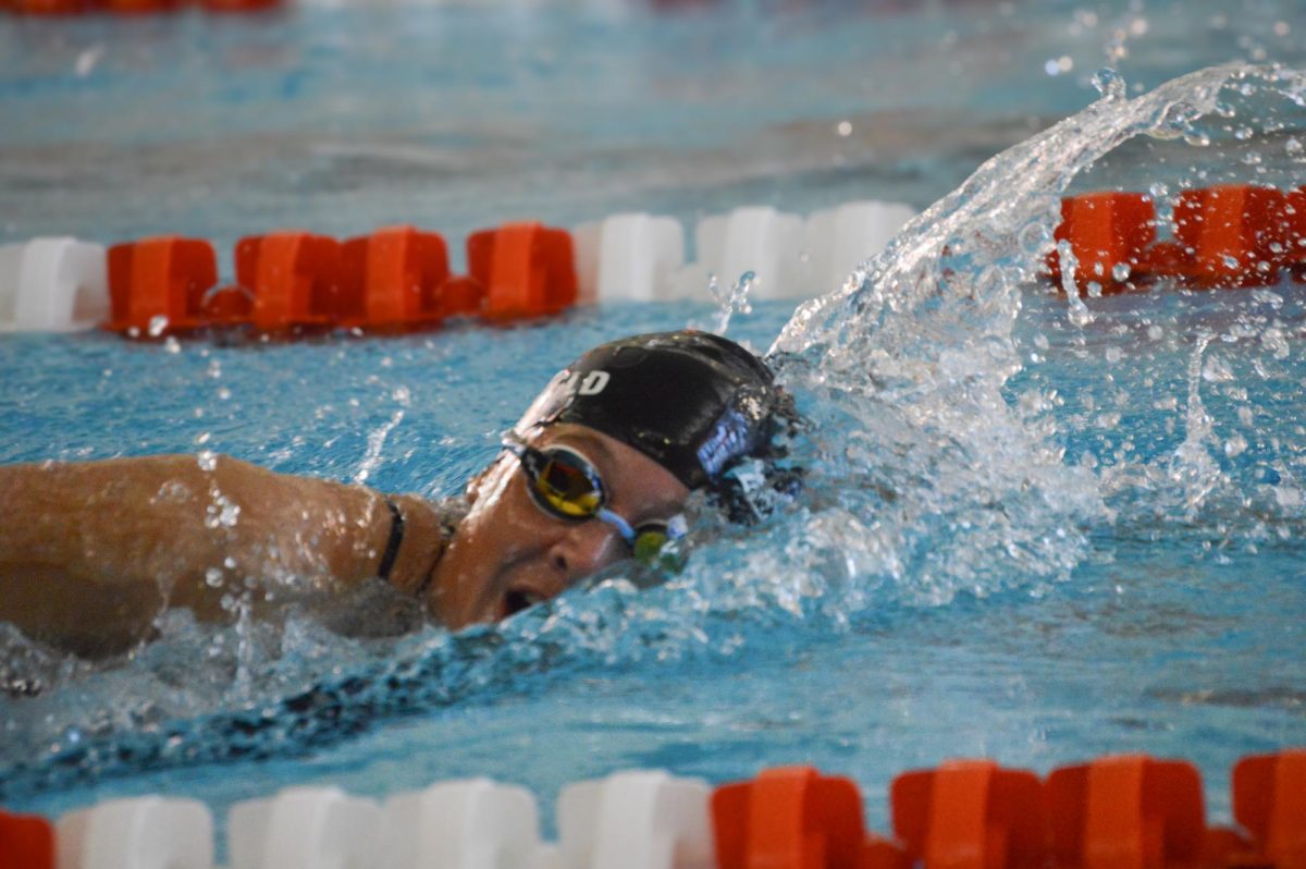 Senior Maggie Burchfield swims the 200-yard freestyle at the Oct. 16, 2025 meet against Hartland High School, earning her second place and a best time.