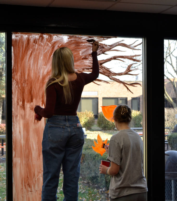 Sierra Club members paint the Sunshine Hall windows in honor of Thanksgiving on Nov. 14, 2025.