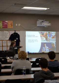 A representative from Compassionate Hospice Care instructs Brighton High School engineering students on cognitive stimulation. The presentation served as an introduction to a wider project, where students had the chance to create devices to assist those living under hospice care.