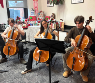 Cellists sophomore Maxwell Hranko, junior Gavin Hoeh and sophomore Ella Tillman perform holiday carols with the Brighton High School orchestra.