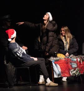 Seniors and Leadership students Evan Cummings, Talia Richards and Delaina Maschke perform at the holiday assembly on Dec. 19, 2025.