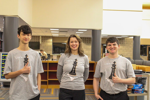 Freshman Mason Karber, Ms. Diane Schandevel and senior Bradley Schwab pose together at a chess tournament hosted at Brighton High School on Jan. 10, 2026.