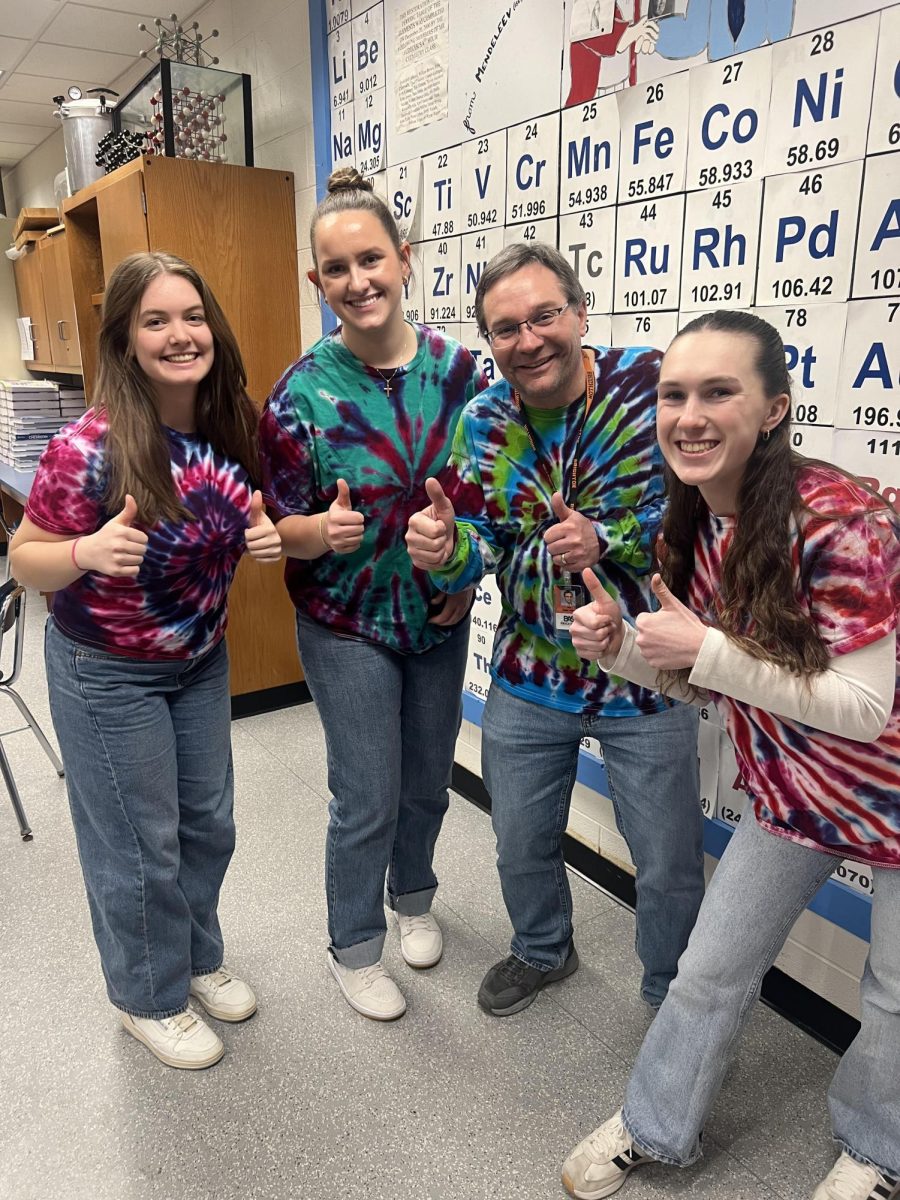 Seniors Isabella Lawlor, Paige Bierlein and Irelynd Otis channel their inner chemistry teacher with Mr. Josef Hudecek. 