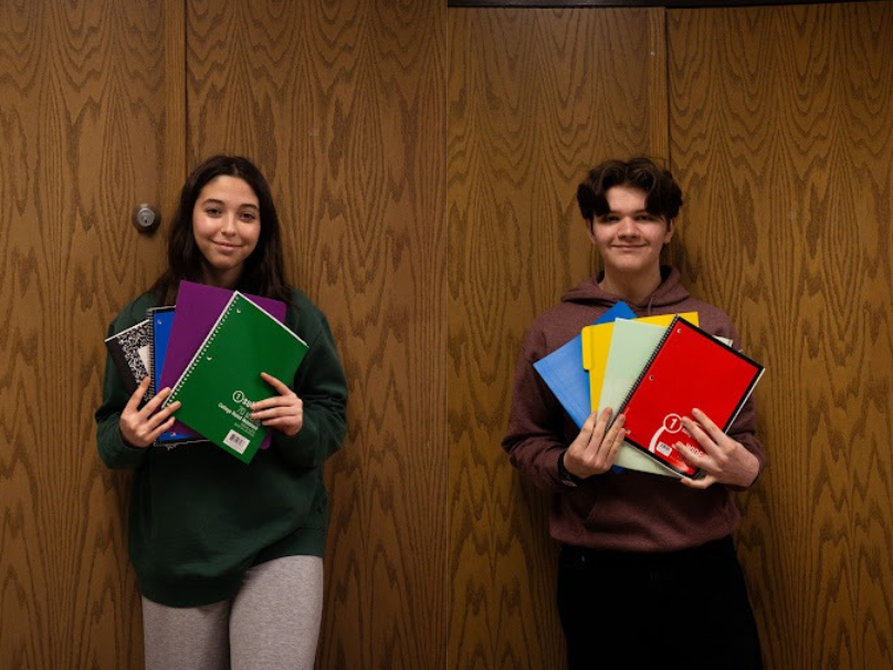 Juniors Nimrie Ramsdell and Gavin Hoeh pose with the different colored folders they use for their classes.