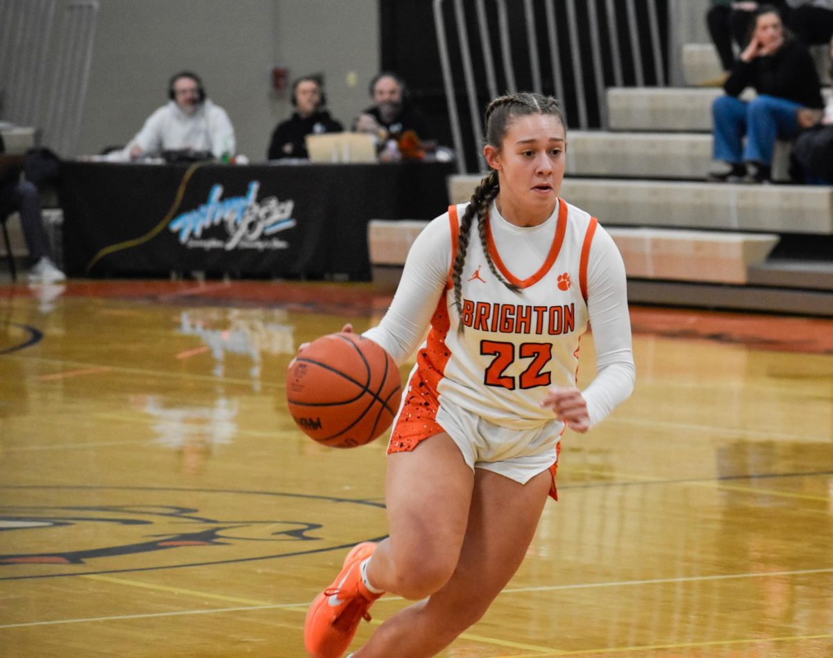 Junior Anna Minnick dribbles the basketball down the court.